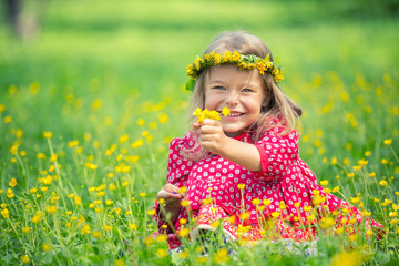 Portrait of happy little girl in spring park