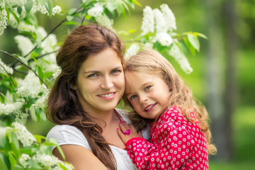 Outdoor portrait of mother and daughter in spring park