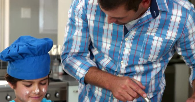 A father and his son are preparing pastries
