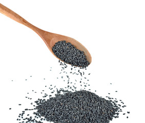 Heap of black sesame on wooden spoon