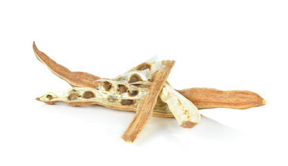 Cutting dry Moringa drumstick and seeds on white background