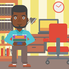 Man holding pile of books.