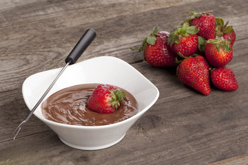 bowl of chocolate dip and strawberries