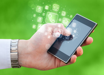 Hand holding smartphone with mobile app icons