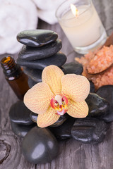 Obraz na płótnie Canvas Spa setting with bath salt, essential oil and zen stones on wooden background 