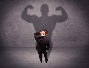 Successful businessman with strong shadow