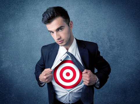 Businessman tearing shirt with target sign on his chest