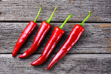 Red chilies on the rusty wooden table