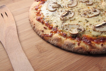 Four cheese pizza with fresh mushrooms on top