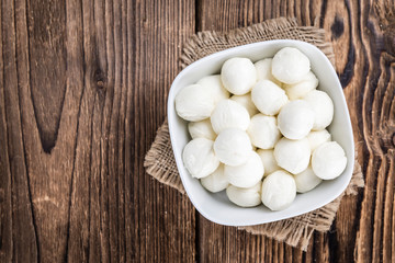 Mozzarella (on wooden background)