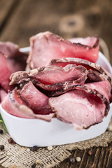 Old wooden table with sliced Roastbeef