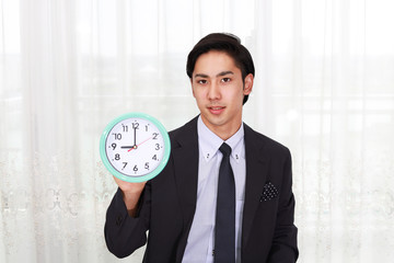 時計を持つ笑顔のビジネスマン