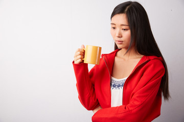 Chinese woman drinking from a mug