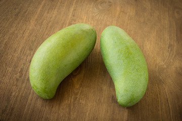 Green mango on a wooden table