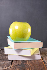 book and green apple