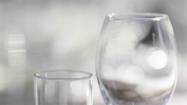 Empty glasses for wine and water set on a festive table in a restaurant – focus shift of glassware. Table decoration