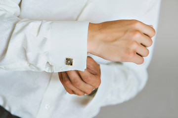 close up of a hand man how wears white shirt and cufflink
