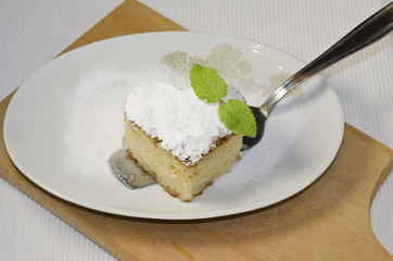 Traditional Turkish dessert revani on wooden board