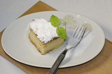 Traditional Turkish dessert revani on wooden board