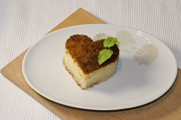 Traditional Turkish dessert revani on wooden board
