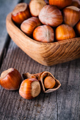 Hazelnuts on a wooden background.