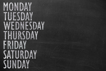 written message 7 day of week on chalk board background 