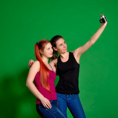 Two young women doing selfie with old camera
