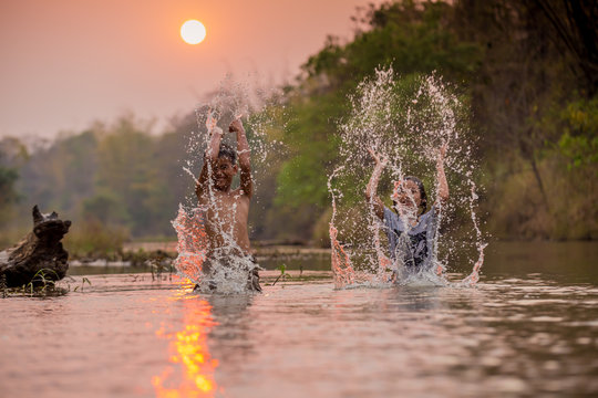 Asian Boy And Girl Playing In The River