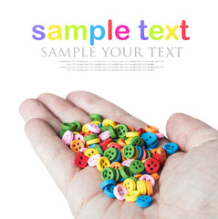 Multi colored buttons in his hand