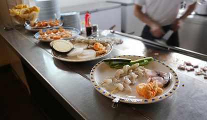 dishes in a Chinese restaurant with the Cook in the background