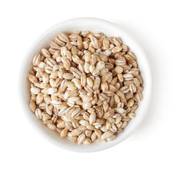 Bowl of pearl barley on white background, top view