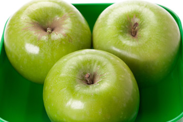 granny smith apples on a green platter