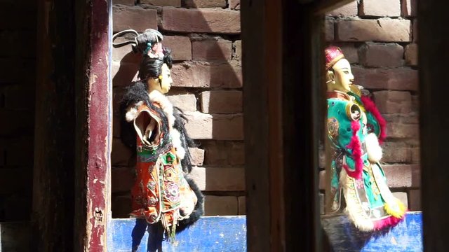 Taiwan Glove puppetry dolls on the brick wall with light