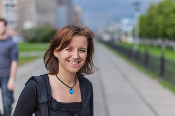 Beautiful woman with a bag on the road.