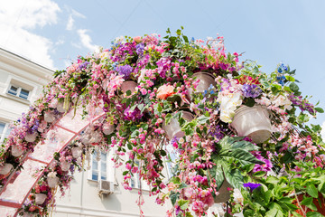Street festival "Moscow Spring" in historical center of Moscow city, Russia. Flower decoration of colorful easter fair.