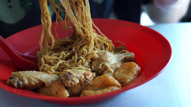 close up of eating noodle, curry chicken dried noodle dish, Malaysian local famous street food, Asian food