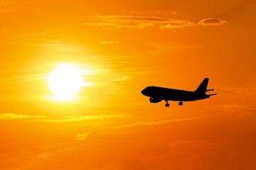 silhouette of airplane at sunset