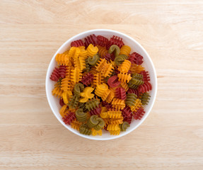 Corn vegetable radiatore pasta in a bowl on wood table top view