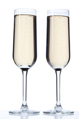 close-up image of two champagne glasses over a white background.