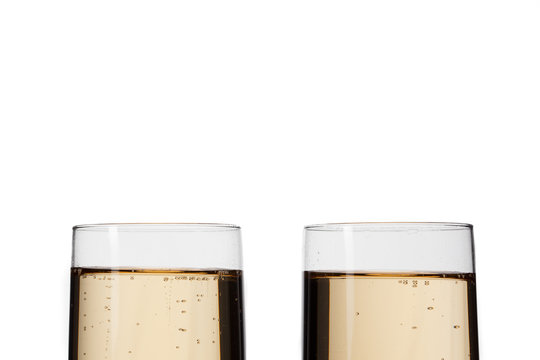 cropped image of champagne flutes over white background.