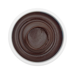 Chocolate fudge frosting in a plastic container on a white background