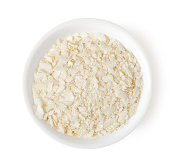 Bowl of rice flakes isolated on white, top view