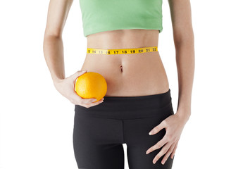 woman holding an orange with cordon tape rolled on her waist.