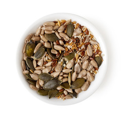 Bowl of mixed seeds isolated on white, top view