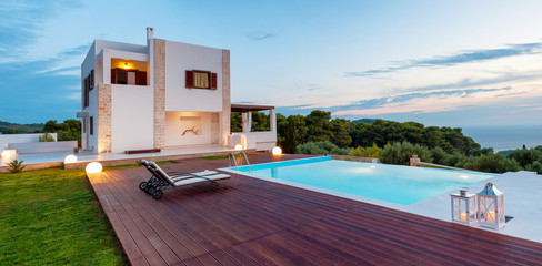 Big luxury pool with villa late in the afternoon - obrazy, fototapety, plakaty