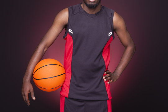 Cropped image of afro american basketball player holding a ball