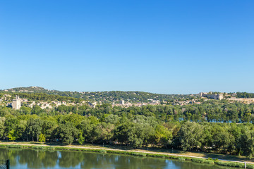 Fototapeta premium Avignon, France. Landscape with the island on the Rhone River. In the background the city of Villeneuve-lès-Avignon and Fort Saint-André (right)