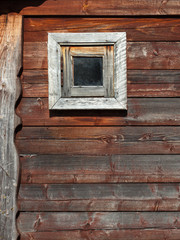 Wooden barn wall with a small window