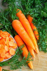Naklejka na ściany i meble Fresh carrots with green leaves