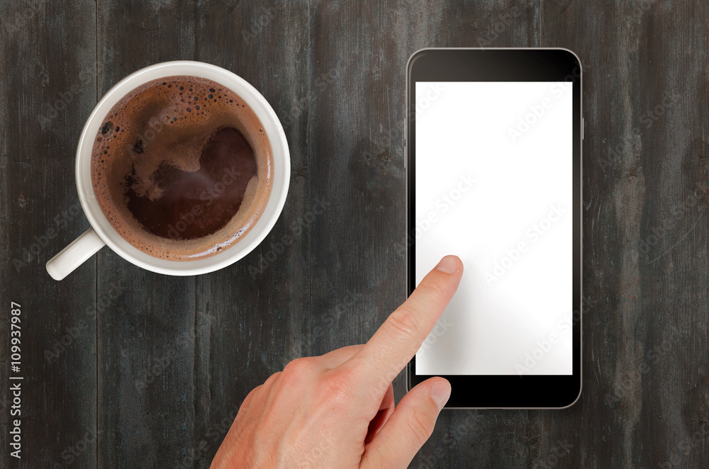 Aufkleber Man touch smart phone with isolated white screen for mockup. Top view scene with coffee.